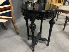 a black table sitting on top of a carpeted floor