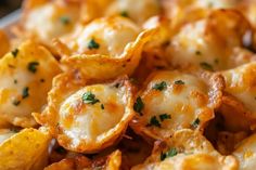 closeup of cheesy potato chips with parsley on top, ready to be eaten