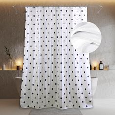 a shower curtain with black and white polka dots