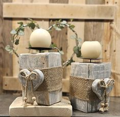 two wooden candlesticks decorated with burlocks and twine tied to them