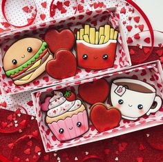 two valentine's day treats in boxes on a table with hearts and polka dots