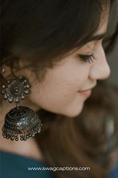 a close up of a person wearing earrings