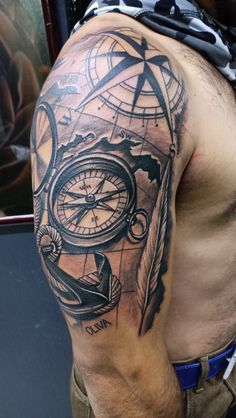 a man with a compass tattoo on his arm