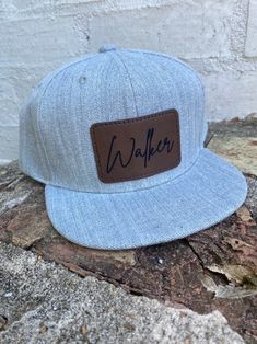 Customize your child's name or team on the front of these heather gray flat bill hats. Hat For Boys, Flat Bill Hats, Sunglasses Strap, Grey Flats, Personalized Leather, Leather Patches, Kid Names, Heather Gray, Custom Name