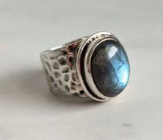 "Is there any stone more mesmerizing than labradorite?! This ring features a large (3/4\" x 1/2\") smooth oval cabochon labradorite stone set in hammered sterling silver (I could not find a mark--the stamp may have worn off--but the ring does test as sterling). Excellent wearable condition. Weighs 14 g." Hammered Silver Ring, Hammered Sterling Silver, Leaf Necklace, Labradorite Stone, Hammered Silver, Made Jewelry, Silver Pieces, Oval Cabochon, Stone Settings