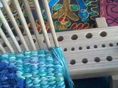 a close up of a wooden chair with yarn on it