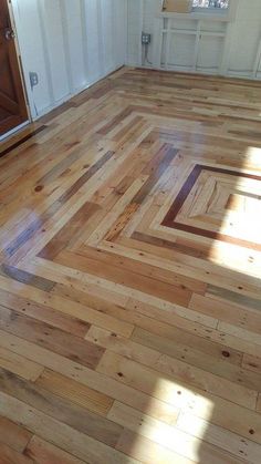 an empty room with hard wood floors and white walls