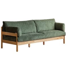 a green couch sitting on top of a wooden frame