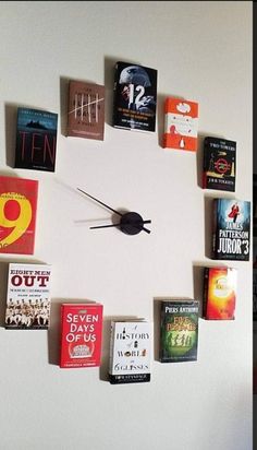 a clock made out of books on the wall