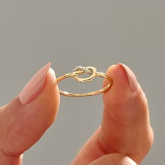 Elevate your style with the Diamond Minimalist Love Knot Ring. Crafted in your choice of 14k, 18k, or 10k solid gold, this ring features an elegant infinity knot design adorned with sparkling pave diamonds. Whether you're expressing your love, celebrating a friendship, or adding a touch of sophistication to your everyday look, this ring is a versatile and meaningful choice. The ring can be made with yellow, rose, or white gold, please choose your size from the dropdown menu options above. 𝐑𝐢𝐧𝐠 𝐃𝐞𝐭𝐚𝐢𝐥𝐬: ❥ Solid gold, available in 10, 14 & 18 karats. ❥ Gold Color Options: White Gold, Yellow Gold, Rose Gold ❥ Top Width: 5.61x8.35 mm ❥ Band Width: 1.14 mm ❥ Thickness: 1.22 mm ❥ Gemstone: Genuine White Diamond ❥ Gem Colour and Clarity: G Colour SI Clarity ❥ Total CTW: 0.028 CTW 𝐂𝐮? Diamond Love Knot Ring, Love Knot Engagement Rings, 14k Gold Diamond Ring For Promise, Infinity Gold Ring, Fine Jewelry 14k Gold Infinity Diamond Ring, 14k Gold Diamond Infinity Ring, 14k Gold Infinity Diamond Ring, 14k Gold Infinity Diamond Ring Fine Jewelry, Infinity Shaped 14k Gold Diamond Ring Gift