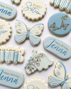 cookies decorated with blue and white icing are arranged in the shape of baby's names