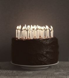 a chocolate cake with white candles on it