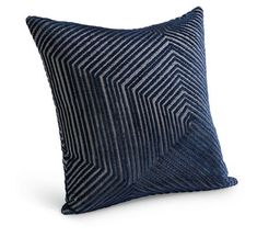 a blue and black pillow on a white background