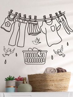 a laundry line with clothes hanging from it and birds flying over the clothesline wall decal