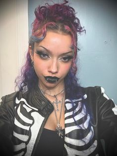 a woman with purple hair and black lipstick