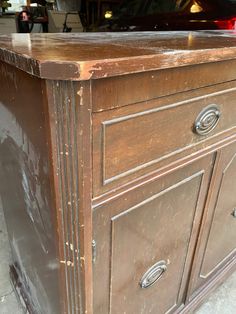 an old wooden dresser with rusted paint on it