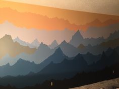 a bedroom with mountains painted on the wall