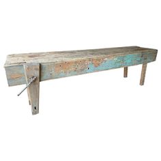 an old wooden bench with nails stuck to it's sides and some paint peeling off the top