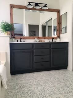 a bathroom with two sinks and a large mirror