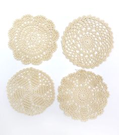 four crocheted doily on a white background