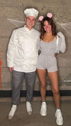 a man and woman dressed up as chefs posing for a photo in front of a brick wall