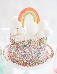 a cake with sprinkles and a rainbow on top