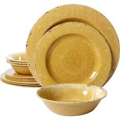 a set of yellow dinnerware with speckled designs on the plates and bowl are $ 25 81