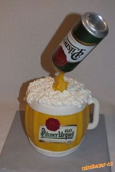 a beer can is being poured into a cupcake with whipped cream and roses on top