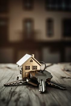 a house key sitting on top of a wooden table