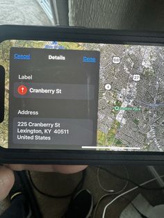 someone is holding up their cell phone to show the location of cranberry st