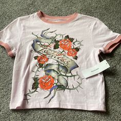 Size Large Graphic Rose Design Baby Tee From Urban Outfitters. Brand New With Tags Summer Graphic Tee With Rose Print, Pink Rose Print Crew Neck T-shirt, Spring Graphic Tee With Rose Print, Trendy Rose Print T-shirt For Spring, Cotton Crew Neck Top With Rose Print, Spring Rose Print Graphic Tee, Cotton Graphic Tee With Rose Print, Pink Rose Print T-shirt For Summer, Urban Outfitters Letter Print T-shirt For Spring