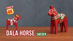 two toy horses on a wooden table with the words dala horse written below them