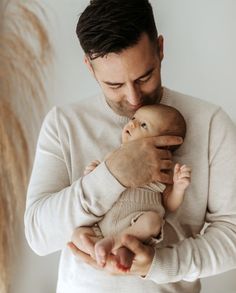 a man holding a baby in his arms