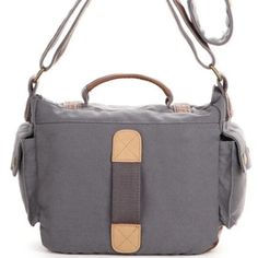 an image of a gray bag with brown straps on it's shoulder and the front pocket open