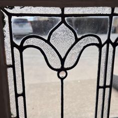 a close up of a glass window with a street in the background