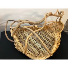 two wicker baskets sitting on top of a black table next to a light bulb