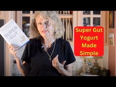 an older woman holding up a book in her hands with the title super gutt yogurt made simple