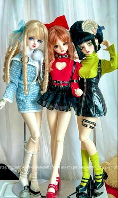 three dolls are standing next to each other