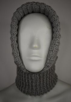 a white mannequin head wearing a gray knitted cowl