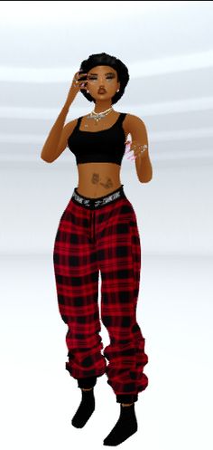 a woman in red and black checkered pants talking on a cell phone while standing next to a white wall