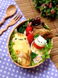 a bowl filled with food sitting on top of a table next to utensils