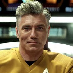 a man with grey hair wearing a star trek uniform