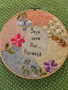 embroidery on fabric with flowers and the words seja como floresga written in it