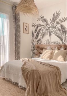 a bedroom with a palm tree mural on the wall above the bed, and a wicker basket hanging from the ceiling