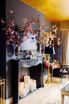 a living room filled with lots of furniture and flowers on top of a fire place