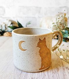 a coffee cup with a cat on it