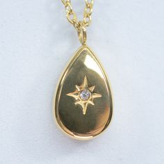 elevate your style with our tears of gold necklace. featuring a beautiful starburst set in a bold teardrop pendant, this piece radiates elegance and charm. the ideal add-on to elevate your layered look and make you shine like the star you are. 18k gold pvd over 316L stainless steel water resistant cz center accent teardrop pendant is 14mm long x 9mm wide and 4mm thick chain is 1mm thick 16" long + 2" extender Gold Teardrop Charm Necklace For Everyday, Everyday Gold Teardrop Charm Necklace, Gold Teardrop Pendant Drop Necklace Tarnish Resistant, Modern Gold Plated Teardrop Pendant Jewelry, Gold Teardrop Necklace With Detachable Pendant, Gold Teardrop Tarnish Resistant Charm Necklaces, Tarnish Resistant Teardrop Pendant Charm Necklace In Yellow Gold, Gold Teardrop Charm Necklaces Tarnish Resistant, Gold Plated Teardrop Drop Necklace