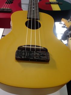 a yellow ukulele sitting on top of a table