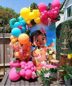 an outdoor birthday party with balloons and decorations on the table, including a photo of princess pooh