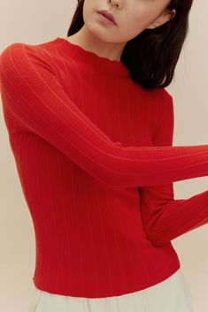 woman in red sweater Fitted Sweater For Winter Layering, Trendy Sweater With Ribbed Neckline For Layering, Stretch Knit Sweater For Work, High Stretch Sweater For Fall, High Stretch Fall Sweater, Snug Fit Ribbed Long Sleeve Tops, Classic Long Sleeve Ribbed Knit Top, Snug Fit Long Sleeve Ribbed Tops, High Stretch Solid Color Sweater For Fall